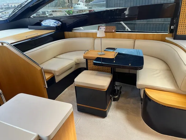  Yacht Photos Pics Luxurious interior of 1998 Riva Dolce Vita yacht with elegant seating and table.