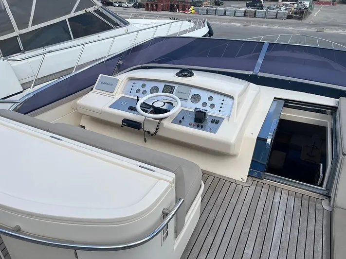  Yacht Photos Pics Cockpit of 1998 Riva Dolce Vita yacht with steering wheel and control panel.