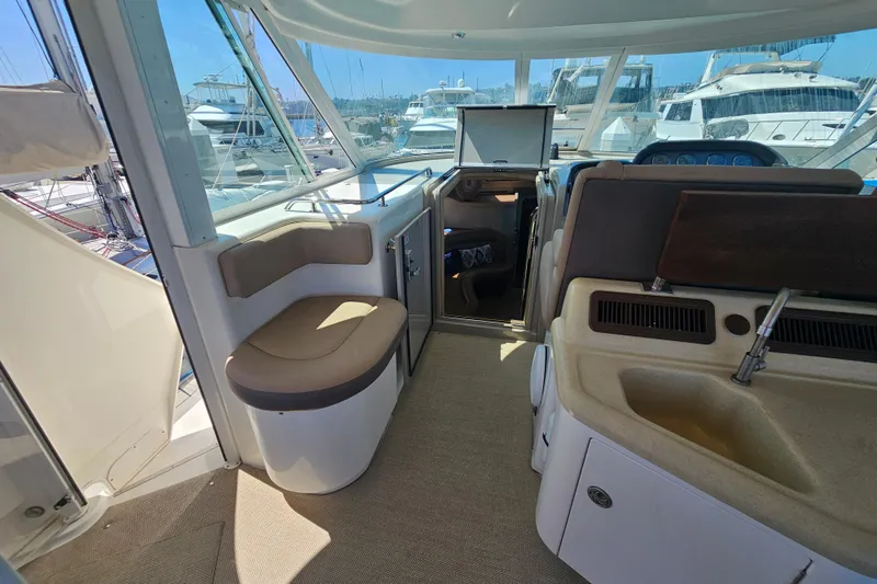 Reflections Yacht Photos Pics 2005 Sea Ray 390 Motor Yacht interior with seating, sink, and marina view.