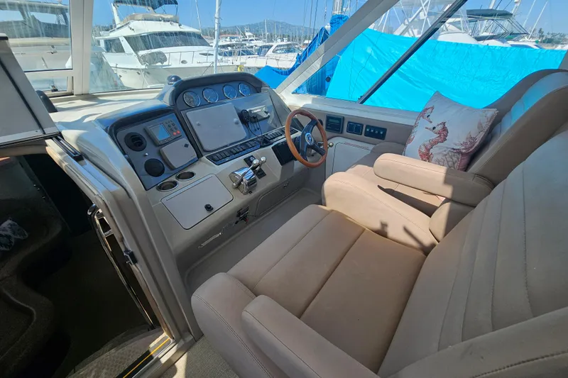 Reflections Yacht Photos Pics 2005 Sea Ray 390 Motor Yacht helm with beige seating and nautical decor.