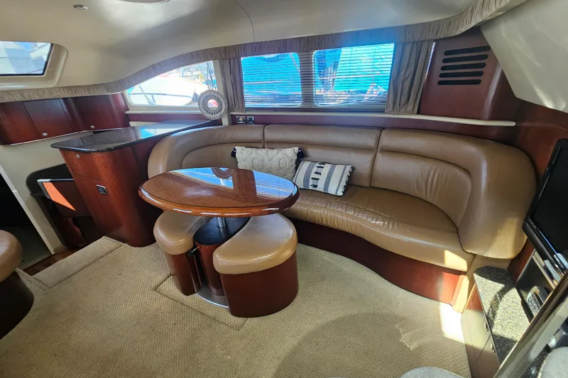 Reflections Yacht Photos Pics Luxurious interior of 2005 Sea Ray 390 Motor Yacht with leather seating and wooden table.