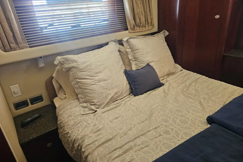 Reflections Yacht Photos Pics Cozy bedroom interior of 2005 Sea Ray 390 Motor Yacht with plush bedding and wooden accents.