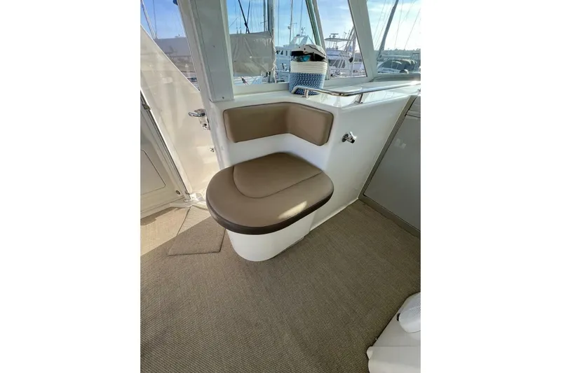 Reflections Yacht Photos Pics 2005 Sea Ray 390 Motor Yacht interior with cushioned seating and window view.