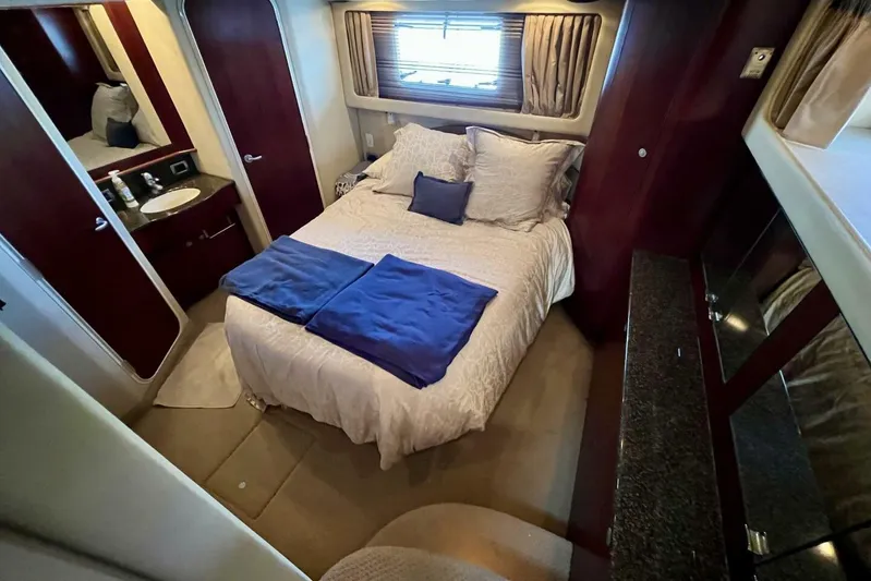 Reflections Yacht Photos Pics Luxurious bedroom interior of 2005 Sea Ray 390 Motor Yacht with cozy bedding and elegant decor.