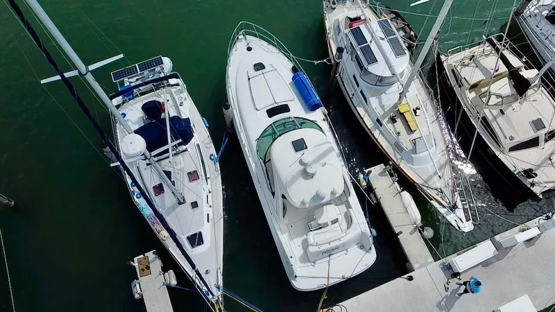 Gloria Yacht Photos Pics Aerial view of a 2007 Sea Ray 40 Sundancer docked among sailboats.