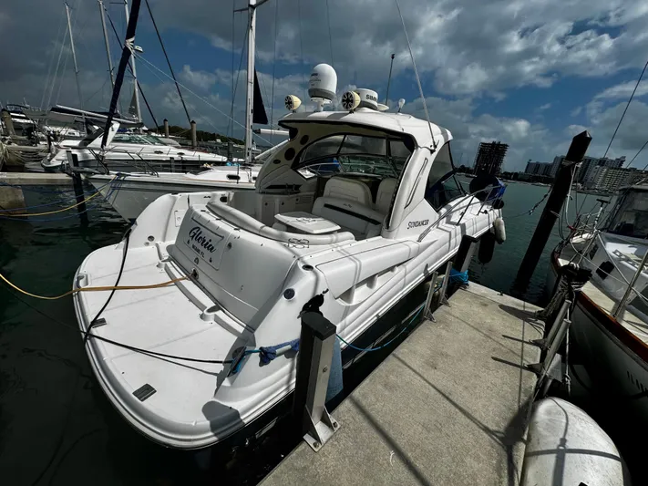 Gloria Yacht Photos Pics 2007 Sea Ray 40 Sundancer yacht docked at marina under cloudy sky.
