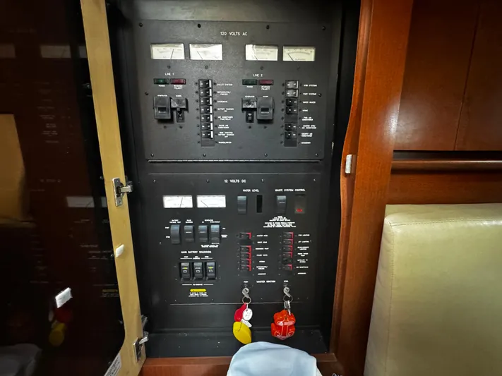 Gloria Yacht Photos Pics Electrical panel inside 2007 Sea Ray 40 Sundancer yacht, showcasing circuit breakers and controls.