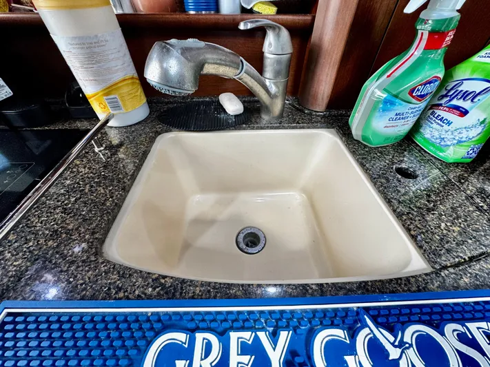 Gloria Yacht Photos Pics Kitchen sink area on a 2007 Sea Ray 40 Sundancer yacht with cleaning supplies.
