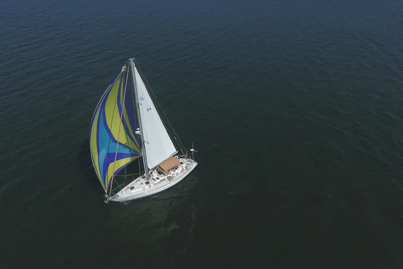 Legacy Yacht Photos Pics Sailboat Hylas 49CC 2012 with colorful spinnaker on open sea.