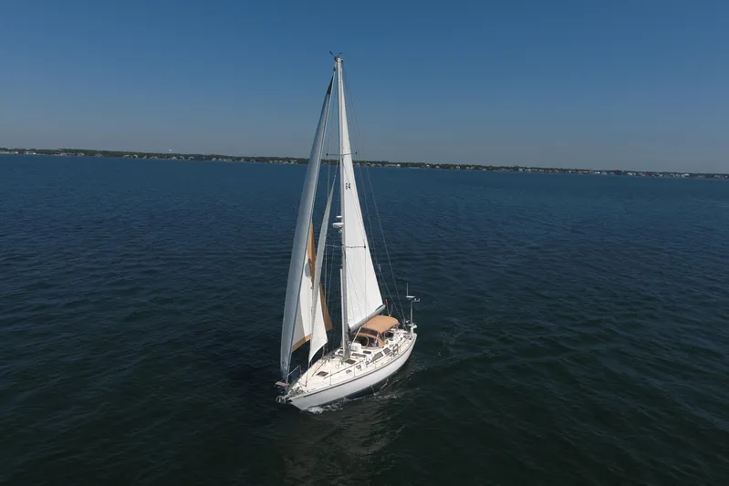 Legacy Yacht Photos Pics Sailing yacht Hylas 49CC 2012 on open water under clear blue sky.