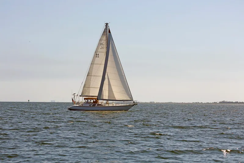 Legacy Yacht Photos Pics Sailboat on open water, Hylas 49CC, 2012 model, under clear sky.