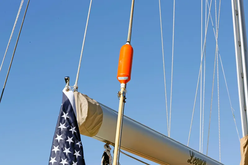 Legacy Yacht Photos Pics Sailboat mast with American flag and orange buoy, Hylas 49CC, 2012 model.
