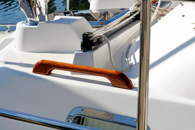 Legacy Yacht Photos Pics Close-up of a 2012 Hylas 49CC yacht deck with wooden handrail and ropes.