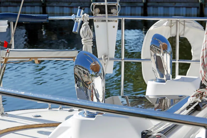 Legacy Yacht Photos Pics Polished chrome details on a 2012 Hylas 49CC yacht deck by the water.