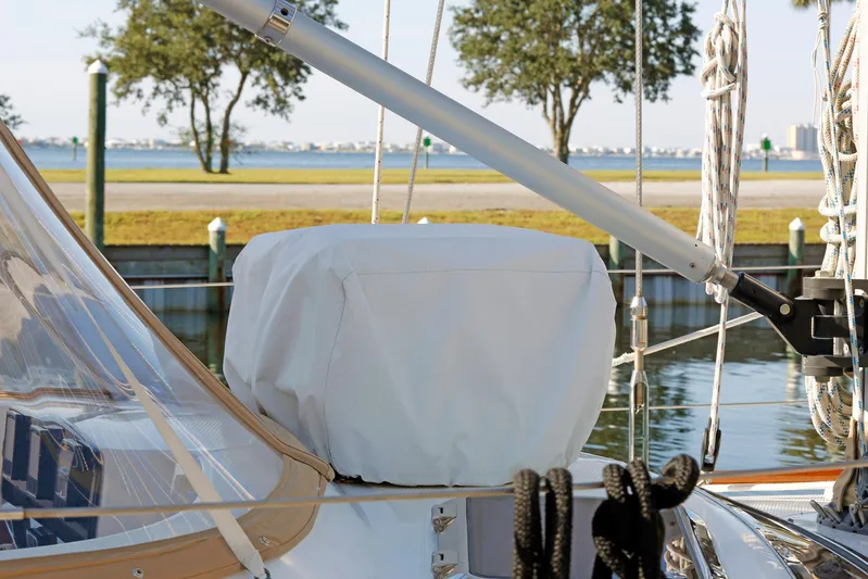 Legacy Yacht Photos Pics Sailboat deck view, Hylas 49CC 2012, with covered equipment and scenic waterfront background.