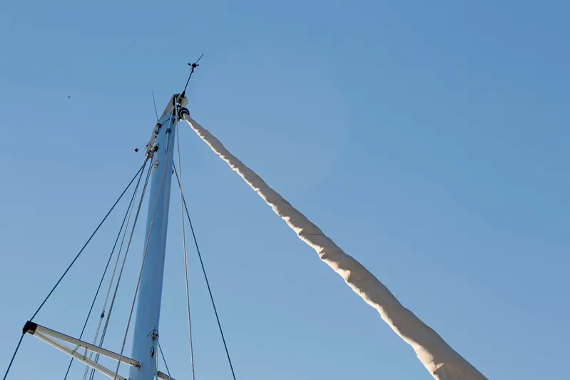 Legacy Yacht Photos Pics Mast of 2012 Hylas 49CC sailboat against clear blue sky.