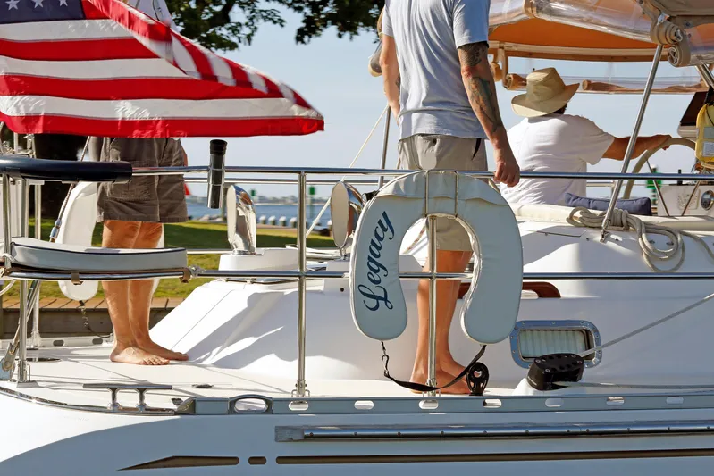 Legacy Yacht Photos Pics People on a 2012 Hylas 49CC sailboat named "Legacy" with an American flag.
