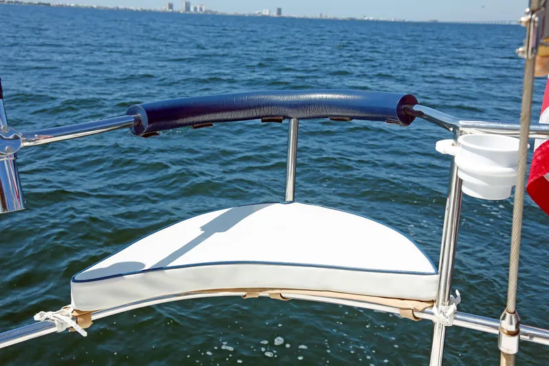 Legacy Yacht Photos Pics Sailboat stern view on water, Hylas 49CC, 2012 model, with city skyline in background.