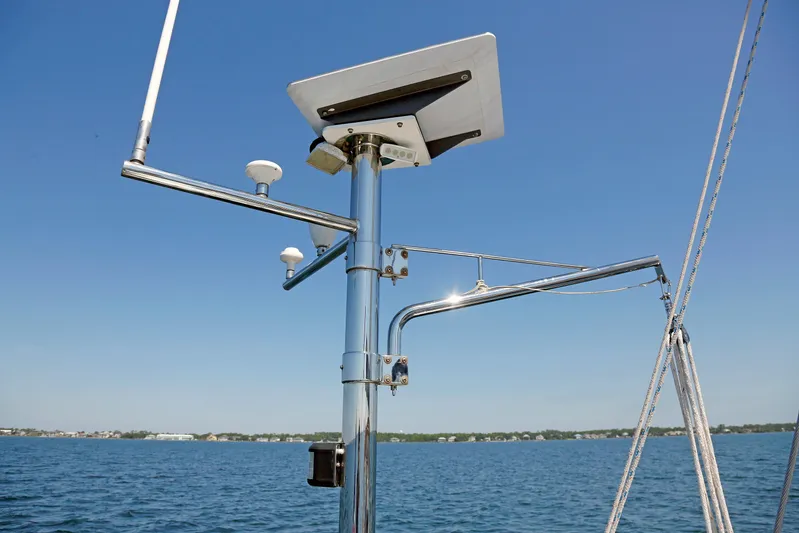 Legacy Yacht Photos Pics Sailboat radar and antenna setup on a 2012 Hylas 49CC, with clear blue sky background.