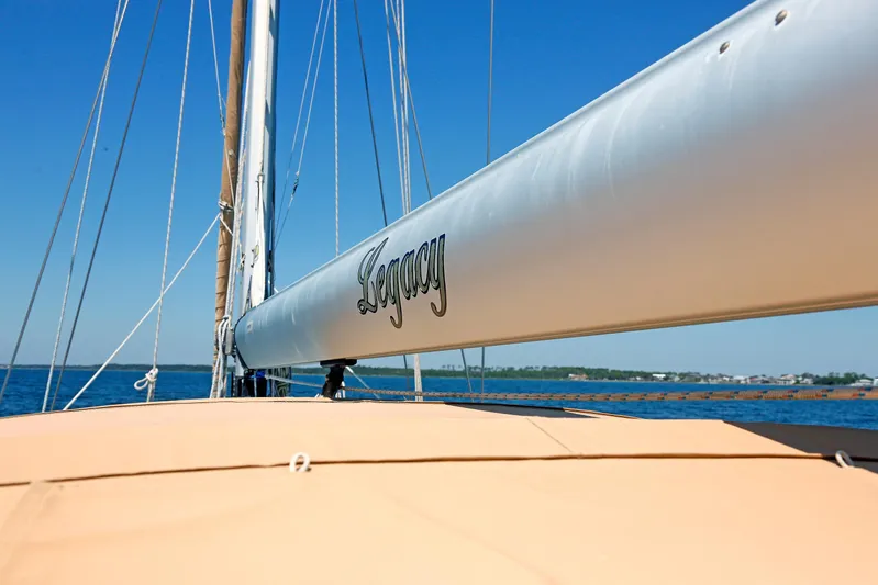 Legacy Yacht Photos Pics Sailboat Hylas 49CC 2012 with "Legacy" on boom, sailing on clear blue water.