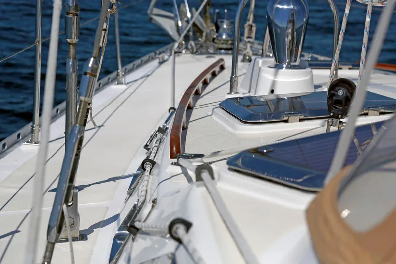 Legacy Yacht Photos Pics Deck view of 2012 Hylas 49CC sailboat with polished fittings and ocean backdrop.
