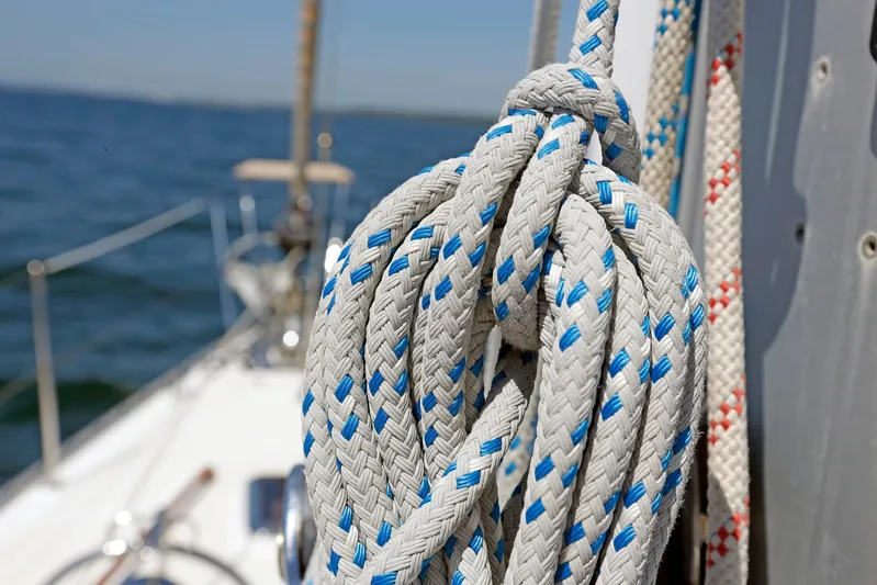 Legacy Yacht Photos Pics Coiled ropes on a 2012 Hylas 49CC sailboat deck, with ocean in background.