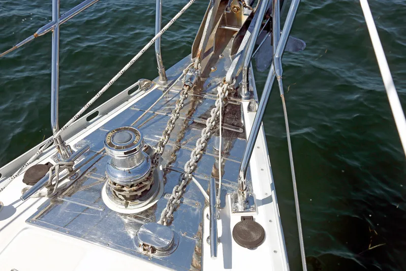 Legacy Yacht Photos Pics Bow of 2012 Hylas 49CC yacht with anchor chain and winch over water.