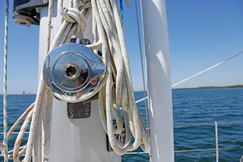 Legacy Yacht Photos Pics Sailboat mast with ropes and winch, Hylas 49CC, 2012, on a sunny day at sea.
