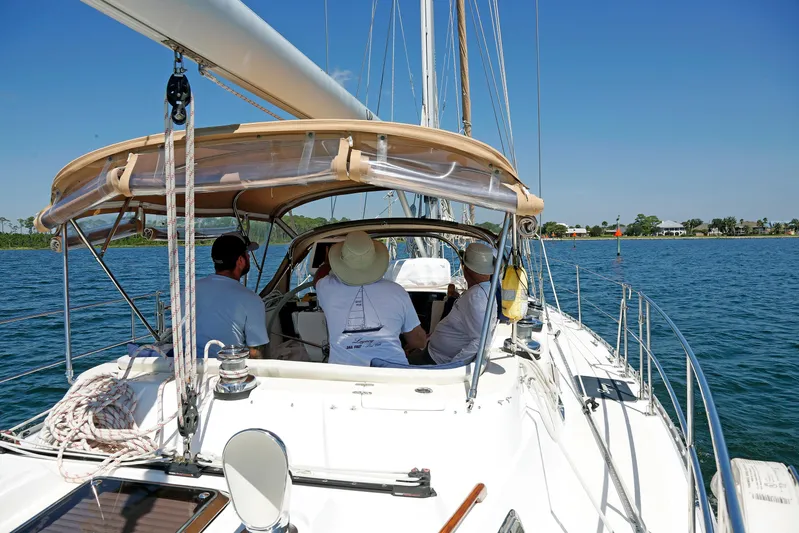 Legacy Yacht Photos Pics Sailing on a 2012 Hylas 49CC yacht with crew, under clear blue skies.