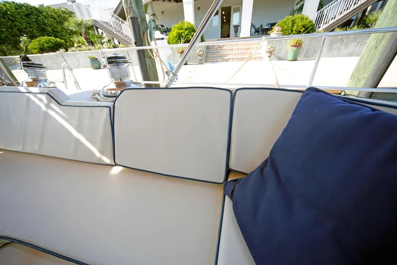 Legacy Yacht Photos Pics Luxurious seating area on a 2012 Hylas 49CC yacht, featuring plush cushions.