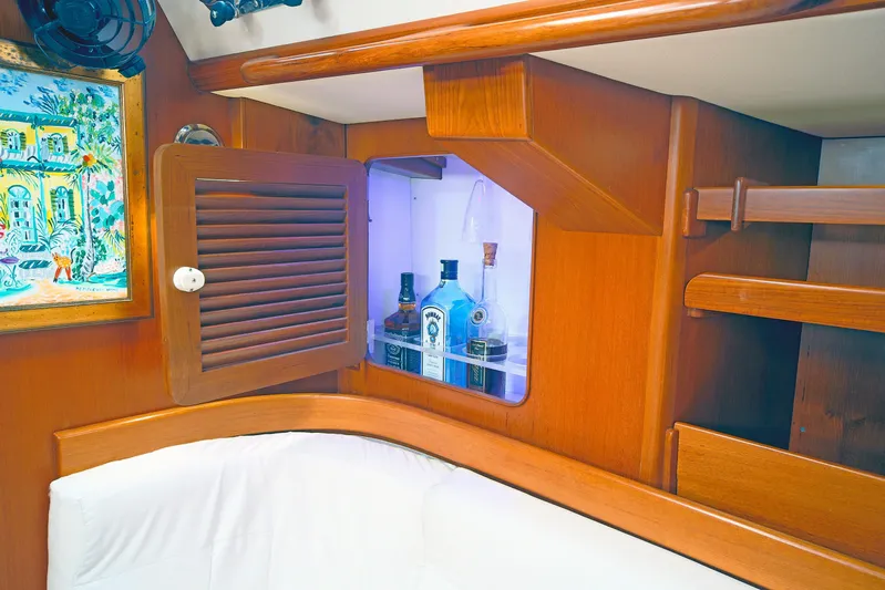Legacy Yacht Photos Pics Interior of 2012 Hylas 49CC yacht with wooden cabinetry and liquor storage.