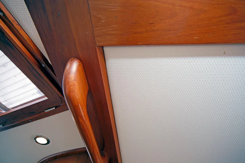 Legacy Yacht Photos Pics Interior of 2012 Hylas 49CC yacht with wooden trim and textured wall panel.