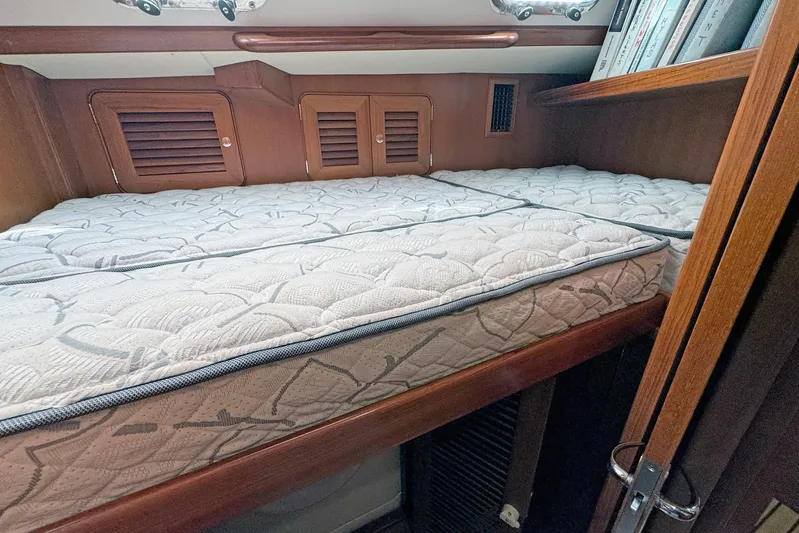 Legacy Yacht Photos Pics Cozy cabin interior of 2012 Hylas 49CC yacht with comfortable bedding.