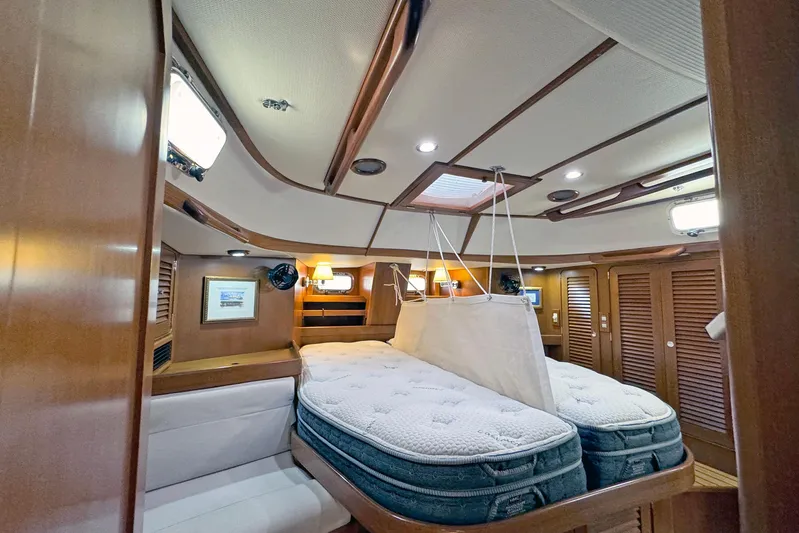 Legacy Yacht Photos Pics Luxurious 2012 Hylas 49CC yacht cabin with twin beds and elegant wood finish.