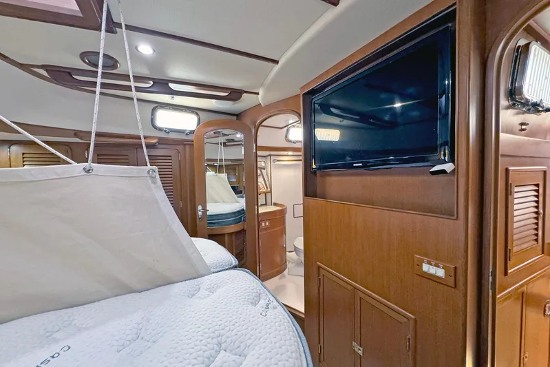 Legacy Yacht Photos Pics Luxurious interior of 2012 Hylas 49CC yacht with wood paneling and modern amenities.