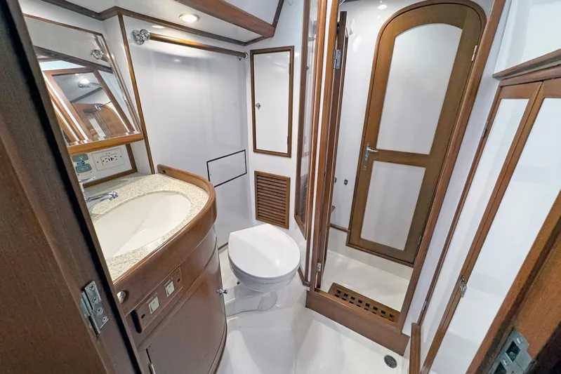 Legacy Yacht Photos Pics Luxurious 2012 Hylas 49CC yacht bathroom with wooden accents and modern fixtures.