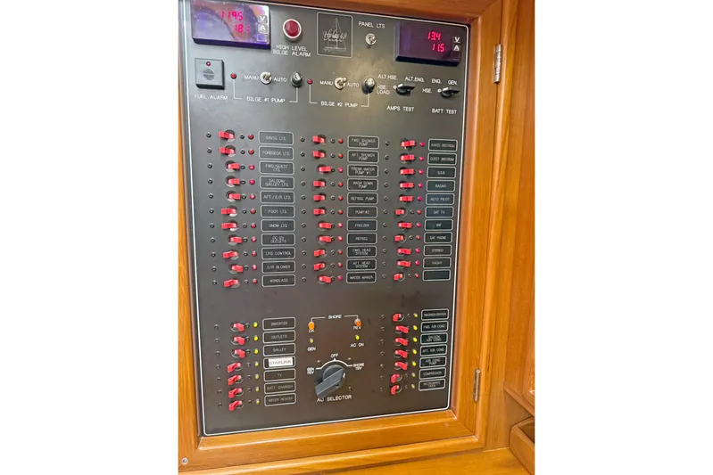 Legacy Yacht Photos Pics Electrical control panel on a 2012 Hylas 49CC yacht, featuring switches and indicators.