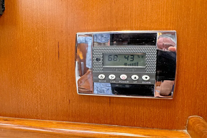 Legacy Yacht Photos Pics Thermostat on Hylas 49CC yacht, displaying 68&deg;F and 43% humidity, mounted on wooden panel.