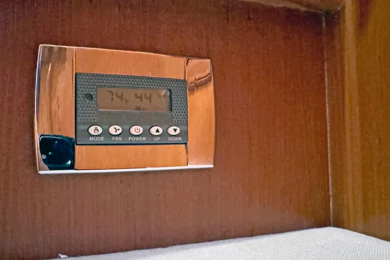 Legacy Yacht Photos Pics Thermostat control panel on a Hylas 49CC yacht, 2012 model, mounted on wooden surface.