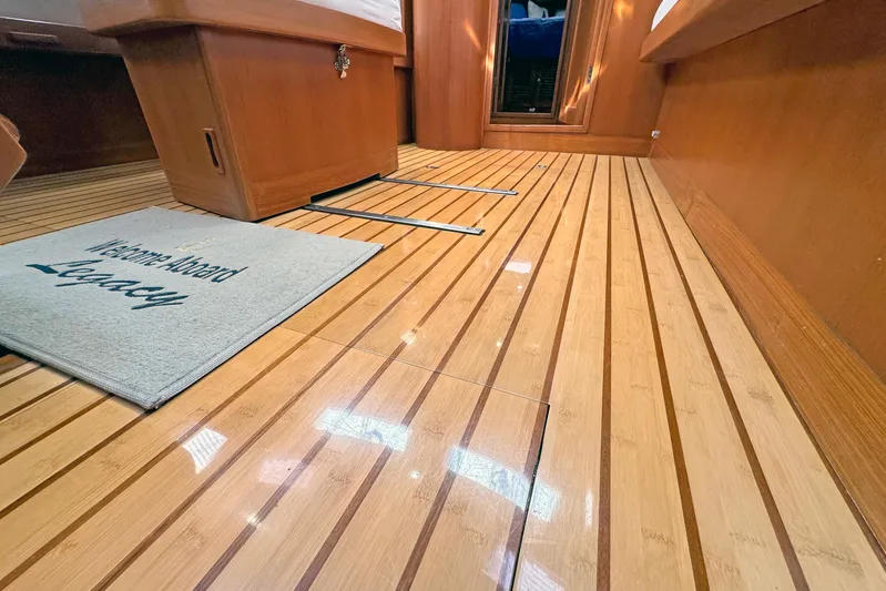 Legacy Yacht Photos Pics Polished wooden floor of 2012 Hylas 49CC yacht interior with welcome mat.