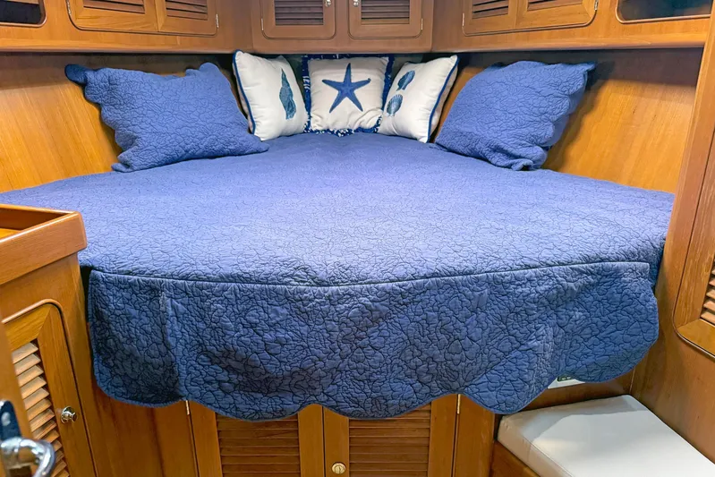 Legacy Yacht Photos Pics Cozy cabin bed with blue quilt and nautical pillows in 2012 Hylas 49CC yacht.