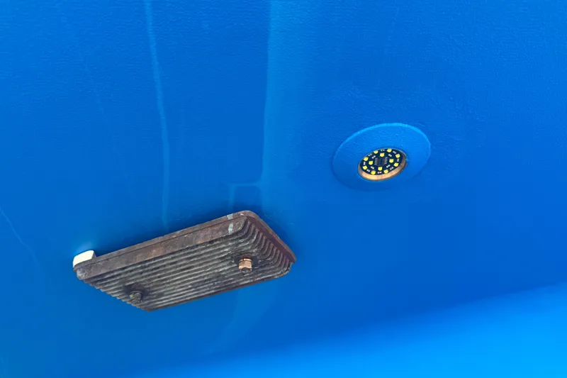 Legacy Yacht Photos Pics Close-up of Hylas 49CC 2012 boat hull with underwater light and metal fixture.