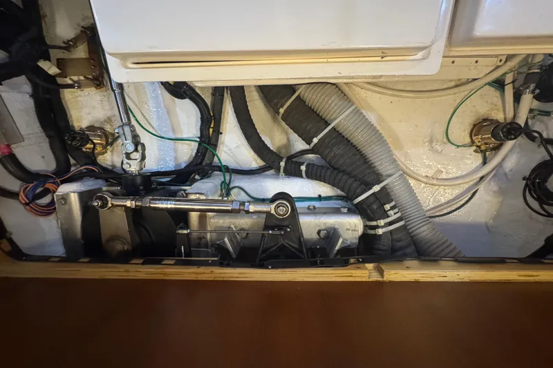 Legacy Yacht Photos Pics Engine compartment of a 2012 Hylas 49CC yacht, showcasing mechanical components and wiring.