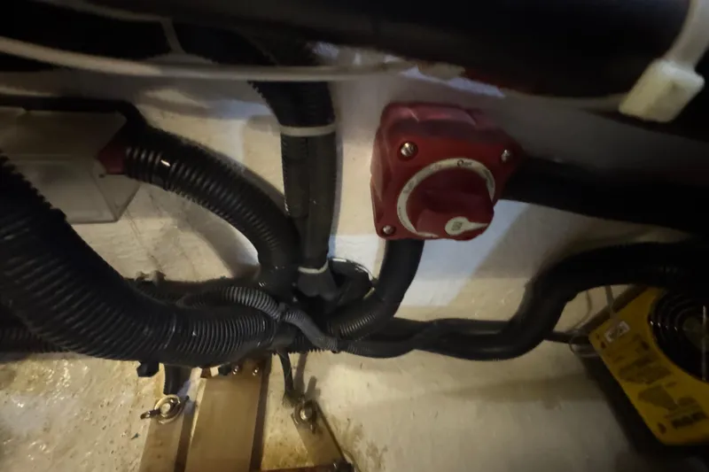 Legacy Yacht Photos Pics Engine compartment of a 2012 Hylas 49CC with wiring and a red control switch.