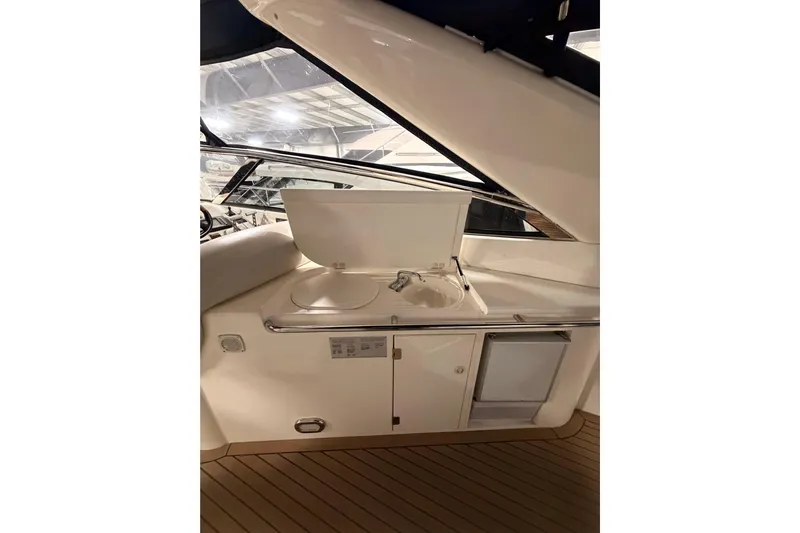 Cover Girl Yacht Photos Pics 1997 Sunseeker Camargue 51 yacht interior with sink and storage area.