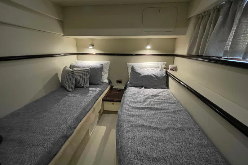 Cover Girl Yacht Photos Pics 1997 Sunseeker Camargue 51 cabin with twin beds, cozy lighting, and elegant decor.