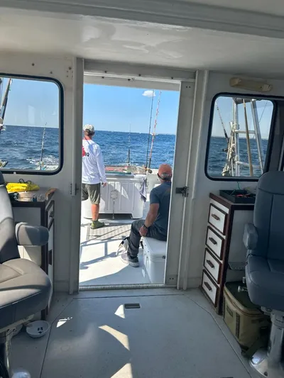 Hey Dad Yacht Photos Pics Interior view of a 1999 Provincial 42 Fishing Boat with two people fishing at sea.