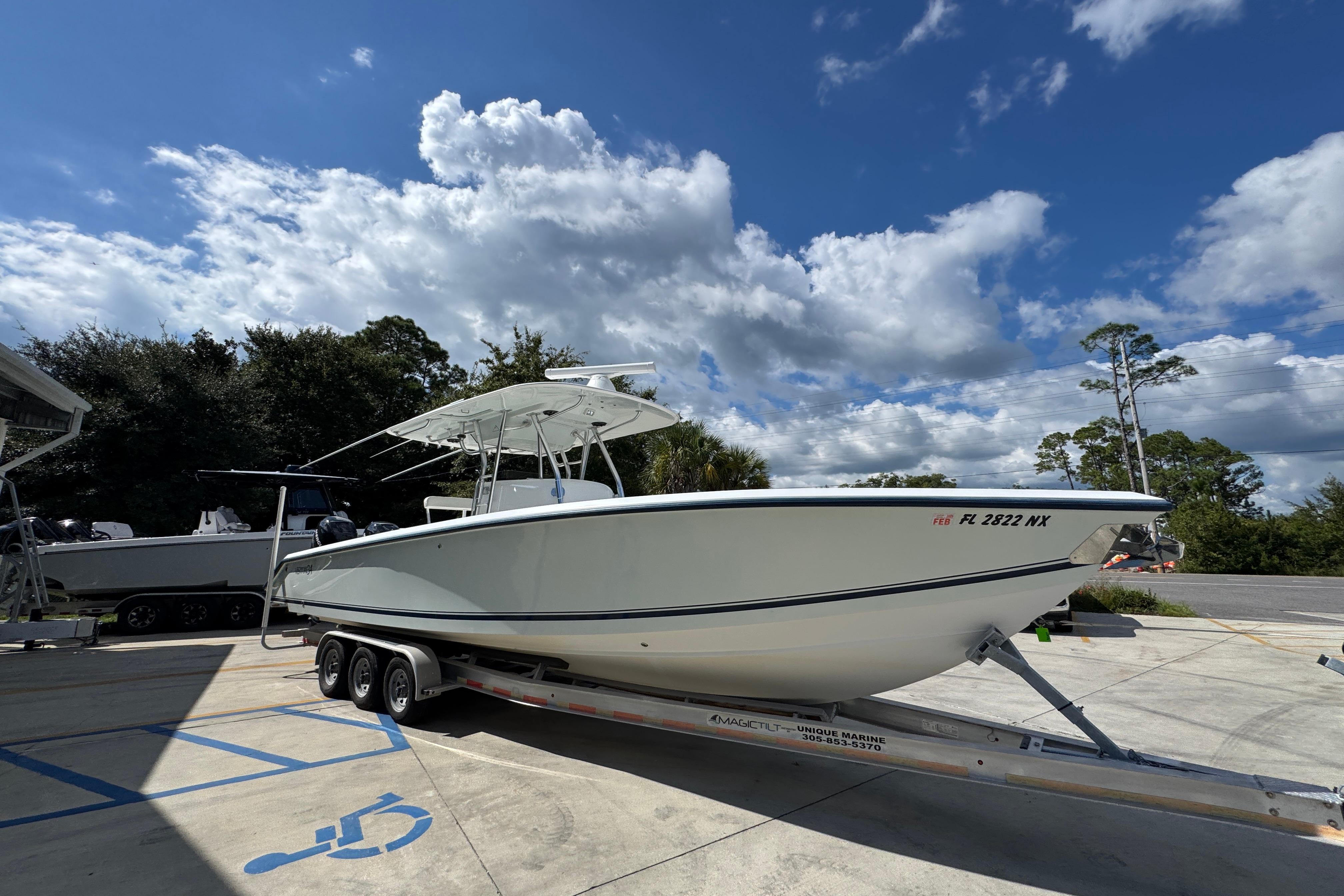 2007 Venture 34 Open boat on trailer under a partly cloudy sky.