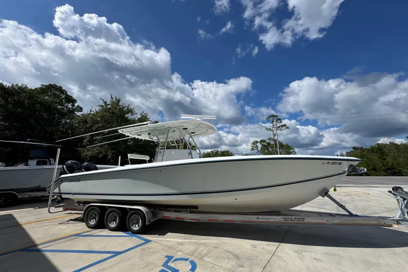  Yacht Photos Pics 2007 Venture 34 Open boat on trailer under a partly cloudy sky.
