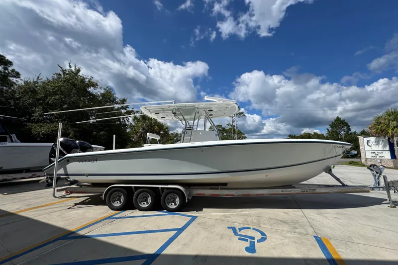  Yacht Photos Pics 2007 Venture 34 Open boat on trailer under a partly cloudy sky.